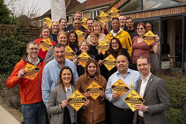 Group of Lib Dem people, holding the Lib Dem diamonds